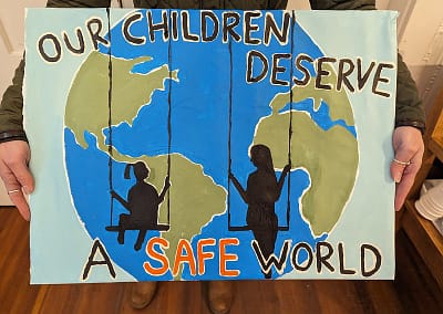 A picture of the world and children on swings - Our children deserve a safe world