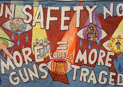 a map of the USA behind GUN safety Now- More = More Tragedy