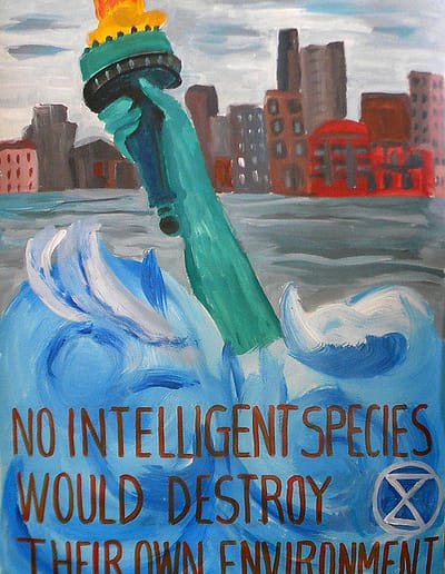 The torch and arm of the Statue of Liberty is all that is visible above water on a poster declaring,"No intelligent species would destroy their own environment."
