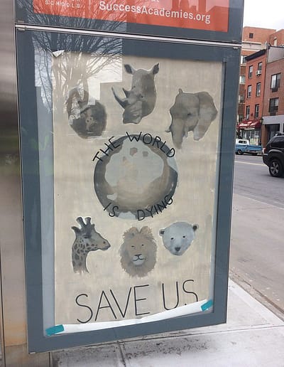 Poster has images of animals from around the world circling a dying world and a plea, " Save Us".