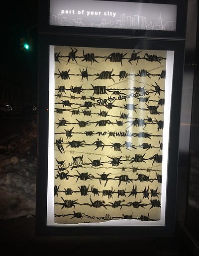 Rows of what appear to be barbed wire are actually human figures and messages - no walls and stop the deportations.
